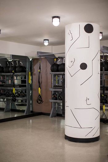 A large white column with a face on it in a garage